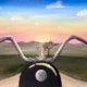 A motorcycle handlebar view of a sunset road with pastel skies, painted during a Paint and Sip Party.