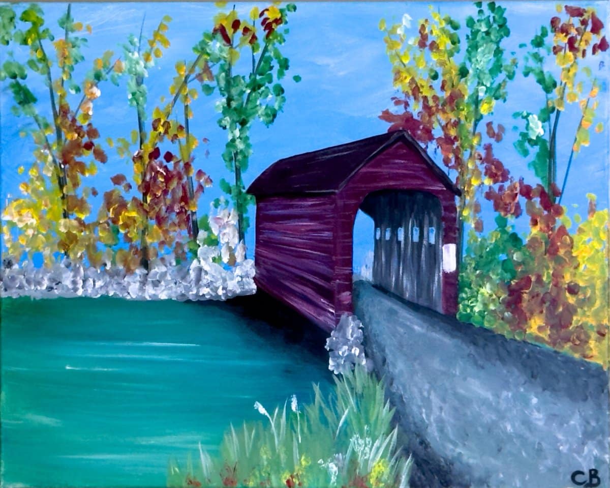 Painting of a red covered bridge surrounded by colorful fall trees and water under a bright blue sky