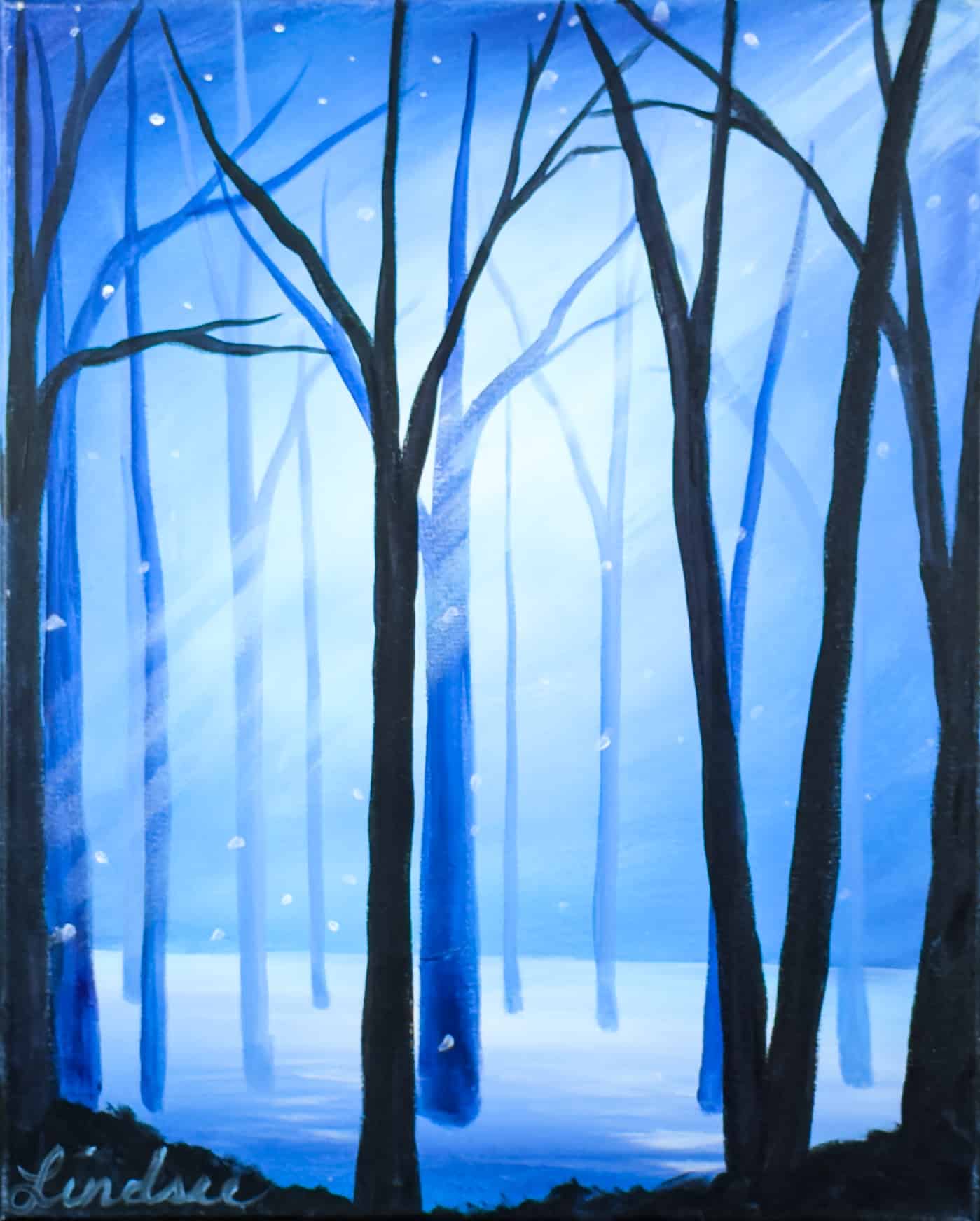 Snowfall in the Forest painting featuring tall bare trees, falling snow, and a glowing blue winter forest scene at a Toledo Paint and Sip Party.