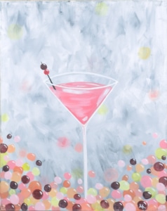 Pink martini cocktail with cherry garnish painted on a soft gray background with colorful confetti accents at a Newport paint and sip party