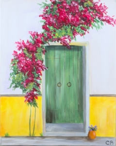A charming green wooden door set into a bright yellow wall, framed by cascading pink bougainvillea vines, with a small potted plant resting on the stone doorstep.
