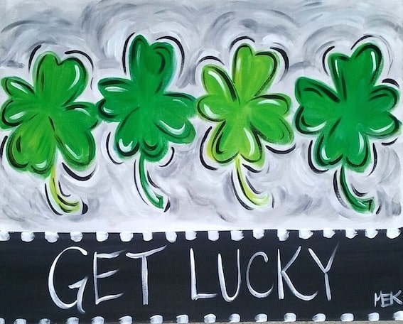 St Patrick’s Day shamrock painting with green clovers and the words Get Lucky on a black and gray background