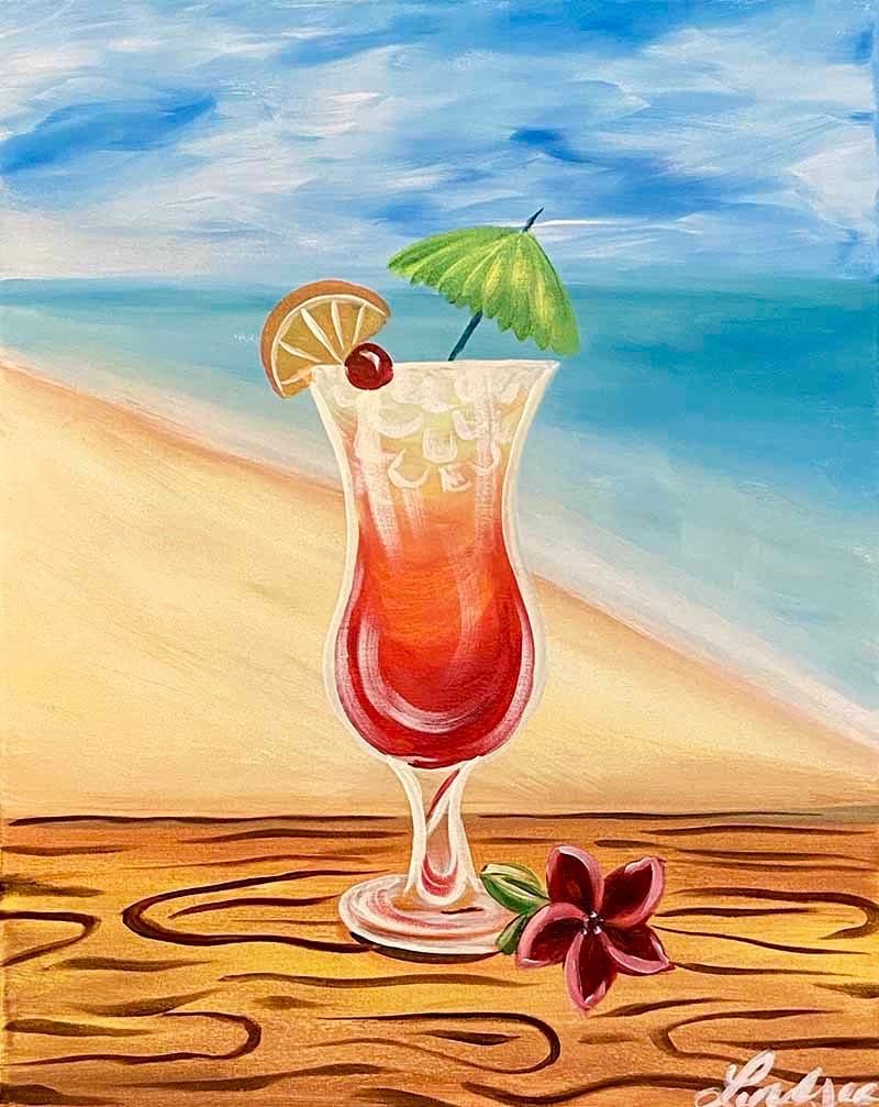 Tropical cocktail with umbrella, cherry, and orange slice sitting on a beach with ocean waves in the background.