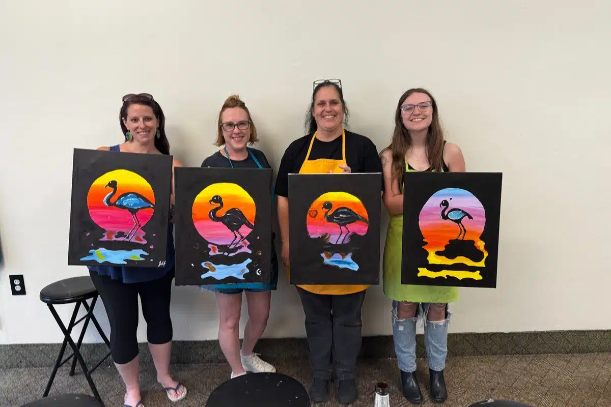 Guests showing their completed classic canvas paintings